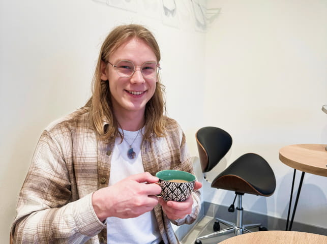 Happy man having tea in hand