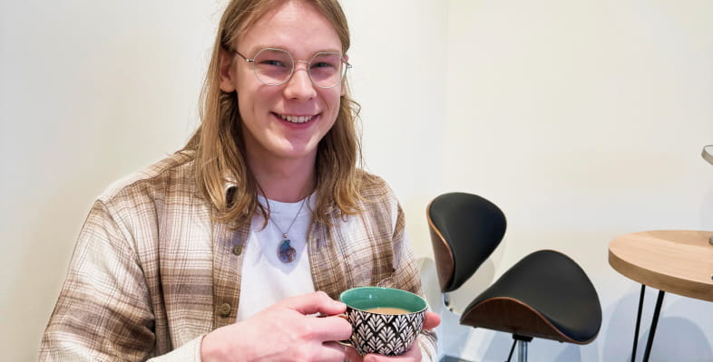 Happy man having tea in hand
